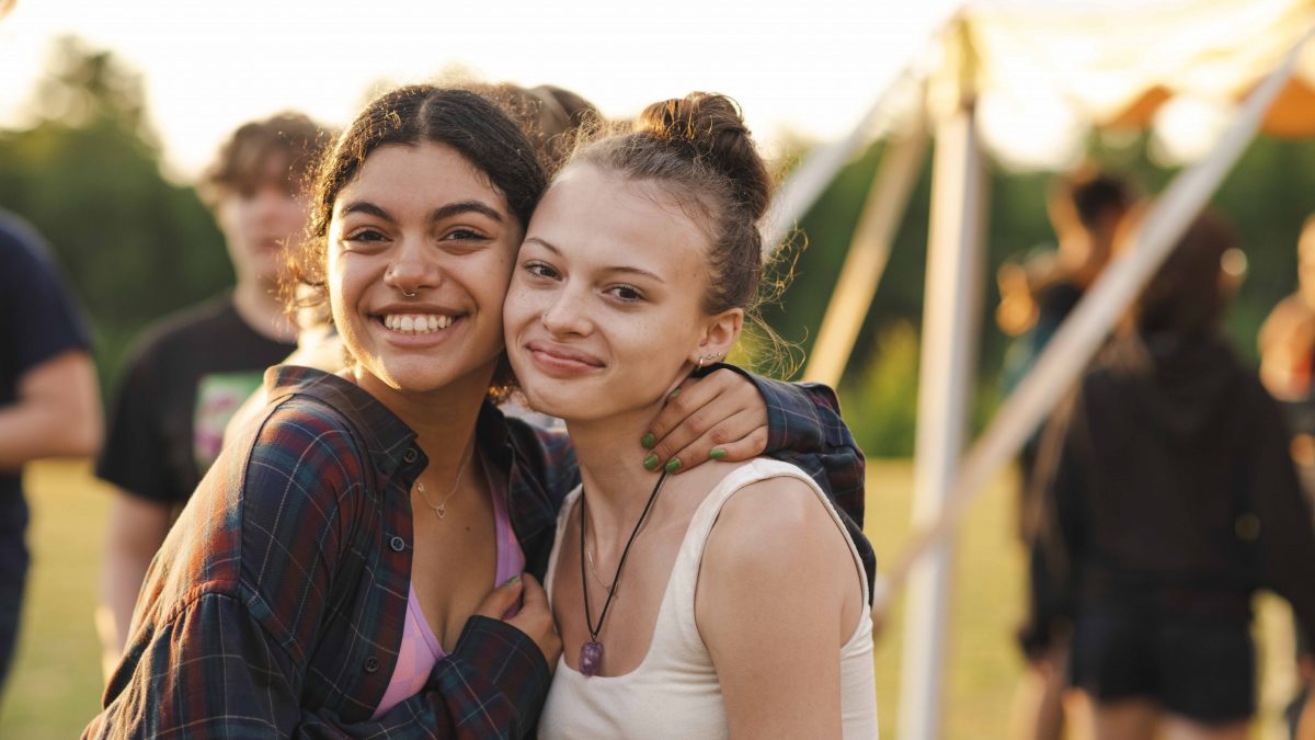 Two campers hug during an activity.